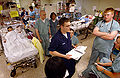 Hospital Corpsman Wade Henry gives a passdown to the night shift in the Intensive Care Unit (ICU) aboard USNS Comfort (T-AH 20).