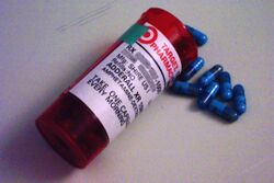 Adderall bottle and capsule