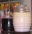 A jar of horchata with a Maneki Neko figurine