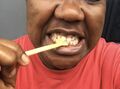 Brushing teeth with chewing stick